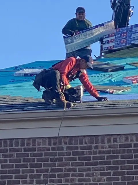 Guy fixing roof | County Roofing Systems