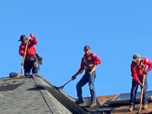 County Roofing Systems employees in our red shirts installing a new roof.