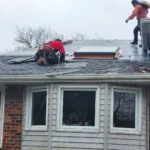 County Roofing Systems working on rainy day